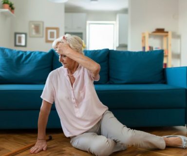 An older woman on the floor. She looks like she just fell over.