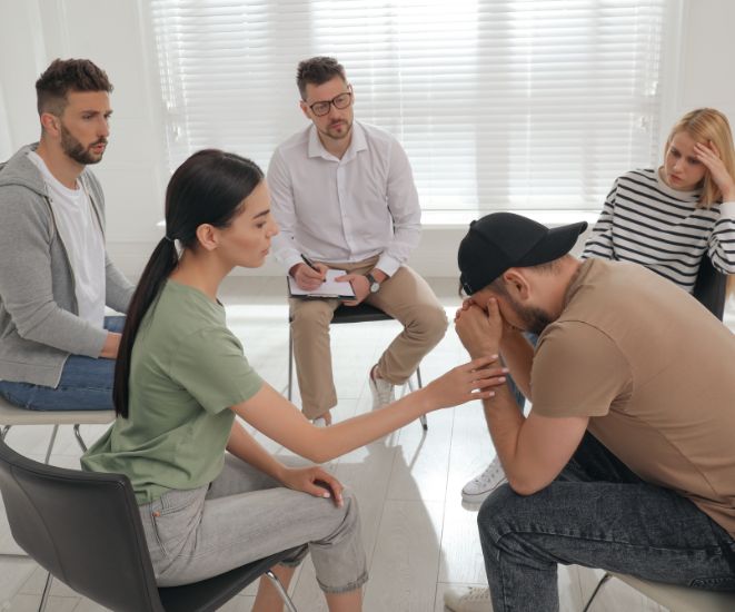 People sitting together in a therapy group session.