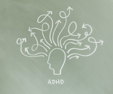 A drawing of the outline of a head in white chalk, with lots of lines and arrows coming out of it to represent ADHD.