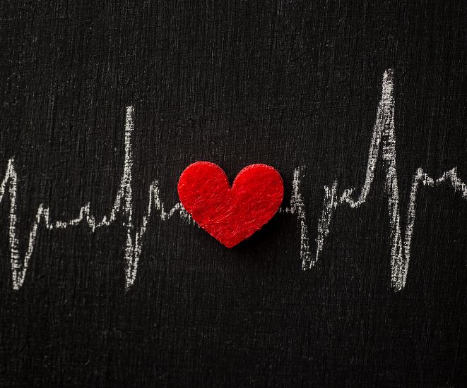 A red heart with white lines showing a heartbeat, on a black background.