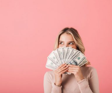 A woman holding a handful of bills.