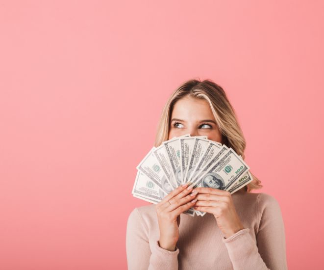 A woman holding a handful of bills.