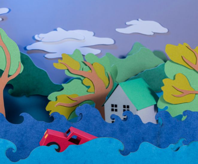 A paper illustration of a house flooding.